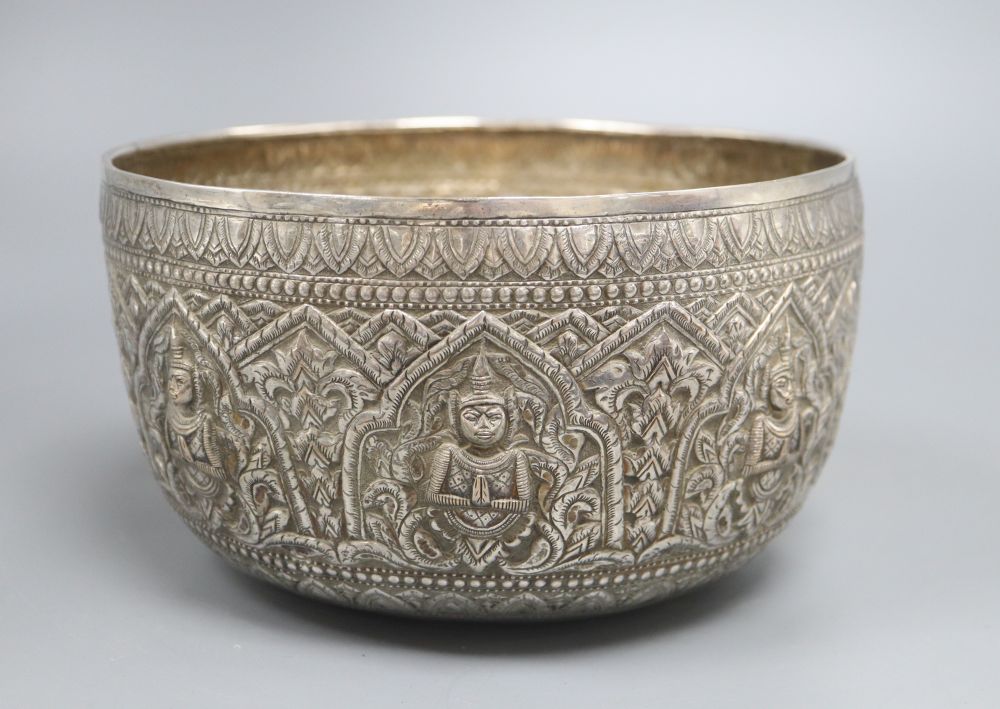 A Burmese silver bowl, c.1900, with repousse Buddha panels, 14.3oz., diameter 21cm